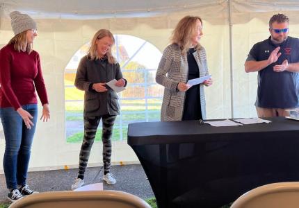 Faith Walker, Katrena Ramsey, and Mayor Josh Miller receive a grant check