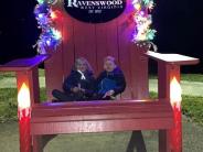 Two children pose in the big red chair