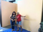 Volunteers painting exhibit space