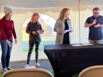 Faith Walker, Katrena Ramsey, and Mayor Josh Miller receive a grant check